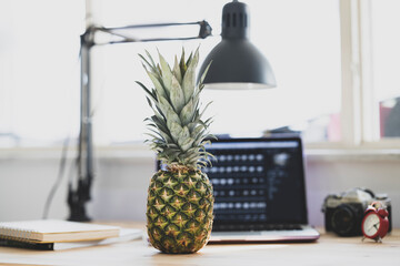 a desk in the office and pineapple on it