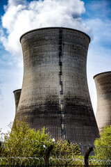 smoking cooling towers of a nuclear power plant with a enormous ladder