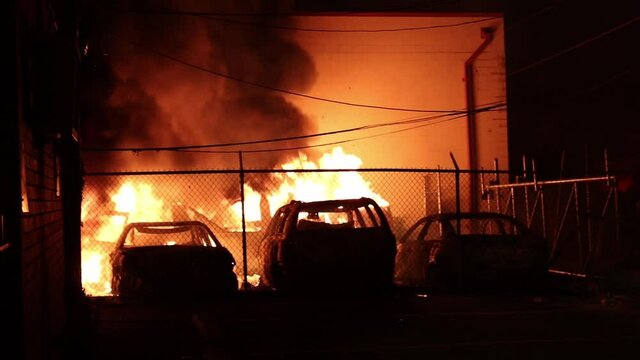parking lot set on fire, cars burning after protest in minneapolis