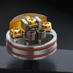 close up, macro shot of dual micro coil in high end rebuildable dripping atomizer for flavour...