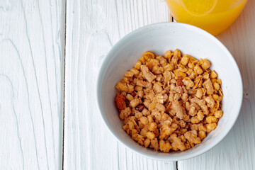 Bowl with granola on wooden table close up