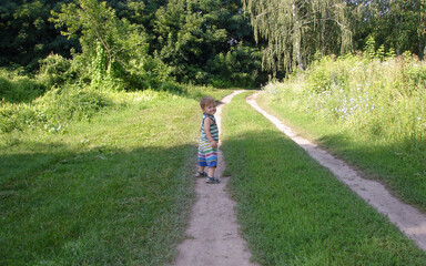 young boy walking in the park