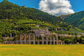 The Roman arches of the ampitheater stand proud at the foot of Mount Ingino in the city of Gubbio,...