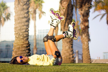 young beautiful athletic young roller skate woman with blue hair and retro sunglasses,...