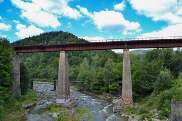  high railway bridge over the river in the mountains.