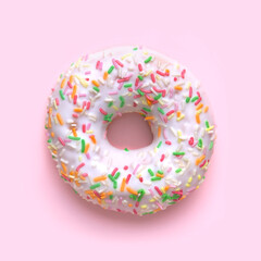 Donut with white frosting and colorful sweet sugar sticks. on a pink background. View from above High quality photo