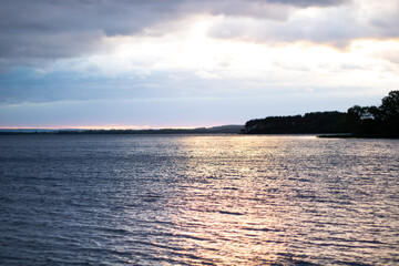 Sunset and blue clouds over the lake. Plenty of room for text.
