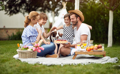 Family enjoying summer together at backyard and eat pie.