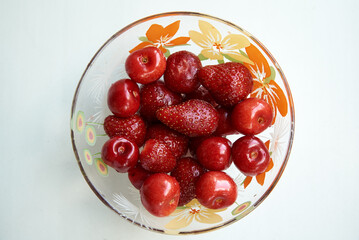 Fresh strawberries and cherries organic in a bowl