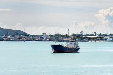 Oil or Chemical Tankers anchor in the harbour near the seaside town in Thailand