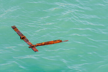 Rusty steel debris floating in the sea