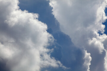 Telephoto closeup photo of dramatic clouds at blue sky