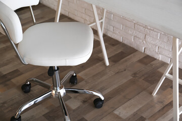 Comfortable office chair near table in room