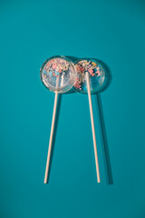 Transparent isomalt lollipops with sprinkles inside