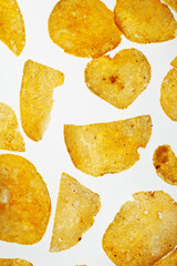 Close-up of potato chips heap on white background