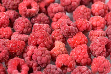 background of frozen raspberries, fresh berries covered with frost, top view. macro photo close-up
