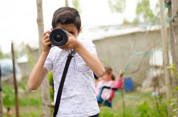 young photographer and boy in white shirt
