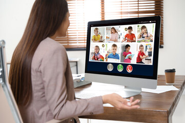Teacher giving online school lesson during quarantine and social distancing due to Covid-19...