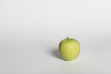green apple on a white background. in daylight