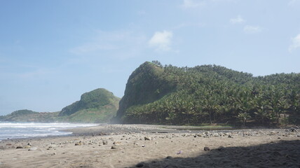 The situation of the beach is very quiet at the end of the virus pandemic with beautiful scenery and many coconut trees on the hill beside the white sand beach