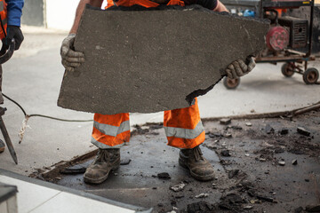 Road repair. Workers are laying asphalt.