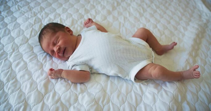 Newborn baby lying on a bed