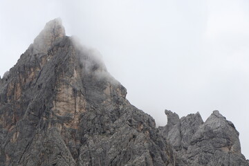 A close up of a rock mountain with clouds