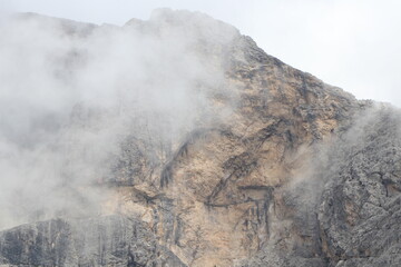A close up of a rock mountain with clouds