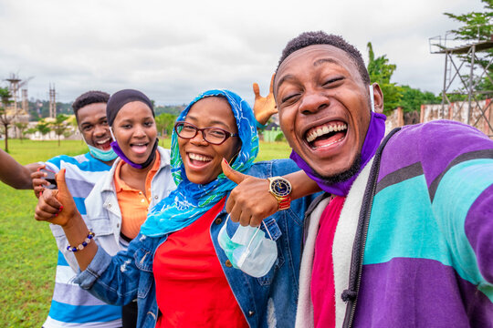 young black friends take a selfie together, feeling excited and happy