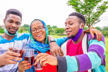 group of young african friends having drinks together