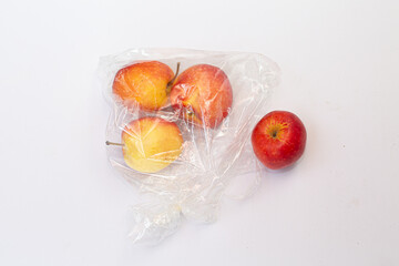 Unpack apple in plastic pack on white background