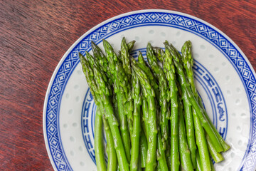 Green asparagus served on a white plate