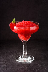 Strawberry margarita cocktail in glass on black background	