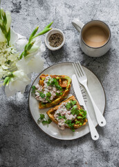 Delicious healthy breakfast - zucchini waffles with tuna, cream cheese pate and coffee on a gray...