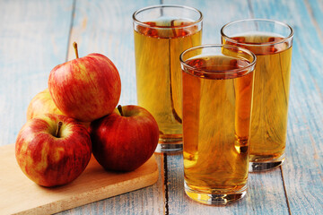 Glasses with apple juice and ripe apples	