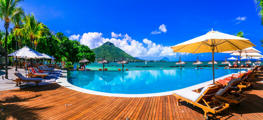 Relaxing holidays in tropical paradise. Mauritius island. Luxury resort territory with swim pool, Flic en Flac beach - obrazy, fototapety, plakaty