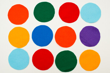 Colored felt circles on white background.