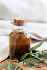 hemp oil and leaves on a wooden table