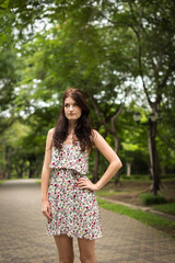 Fototapeta premium Portrait of young beautiful woman at the park outdoors