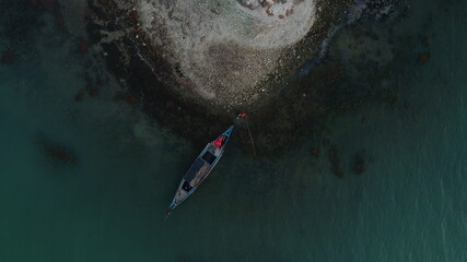 Drone view of a couple relaxing on a boat.