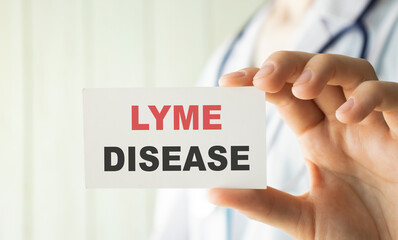 Lyme disease words written on card Doctor's hand shows Medical concept.