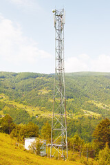 Obraz premium 5G internet tower in the mountains in summer.