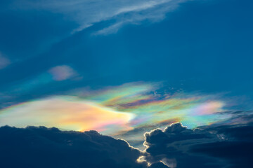 The beauty of the rainbow clouds Above the black clouds in the evening.