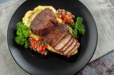 Beef medallions with tomato salsa and cream polenta
