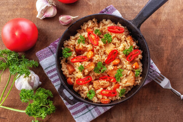 Rice with meat, vegetables and parsley in a serving pan