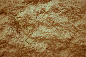 Background stone wall, yellow texture with stones.