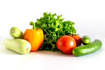 Assortment of healthy food, fresh green red organic vegetables on white background