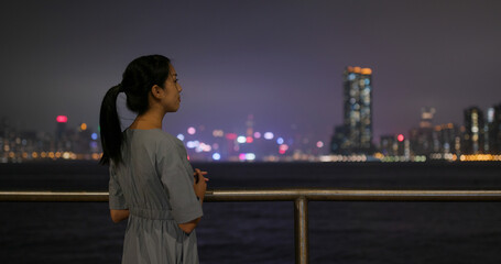 Woman look at the city at night