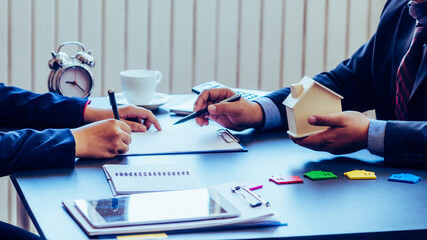 Businessmen and real estate investors are discussing with house and land brokers to sign contracts...