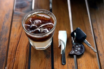 Ice Coffee and Car Key on a wooden table